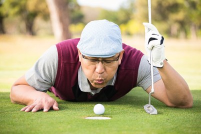 Golfer blowing ball in the hole